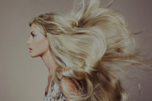 Woman with flowing blonde hair in profile.