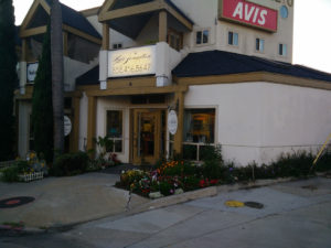 Jewelry store exterior with garden and signage.